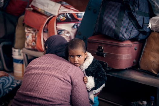 A touching scene of a mother and child surrounded by luggage, capturing the essence of travel and resilience.