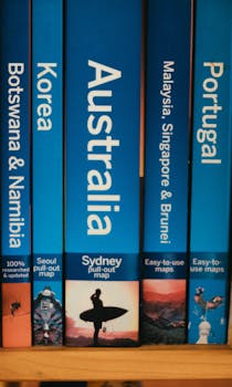 Close-up of travel guidebooks showcasing countries with vibrant blue covers.