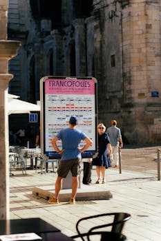 People check the FrancoFolies festival poster in La Rochelle, France.