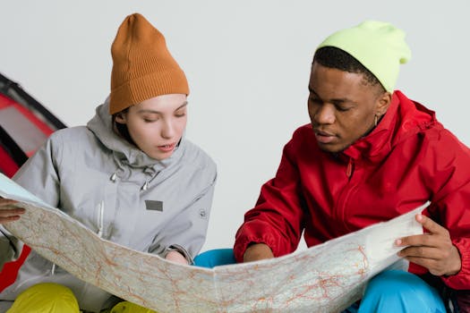 Two young adults studying a map, preparing for a travel adventure together.